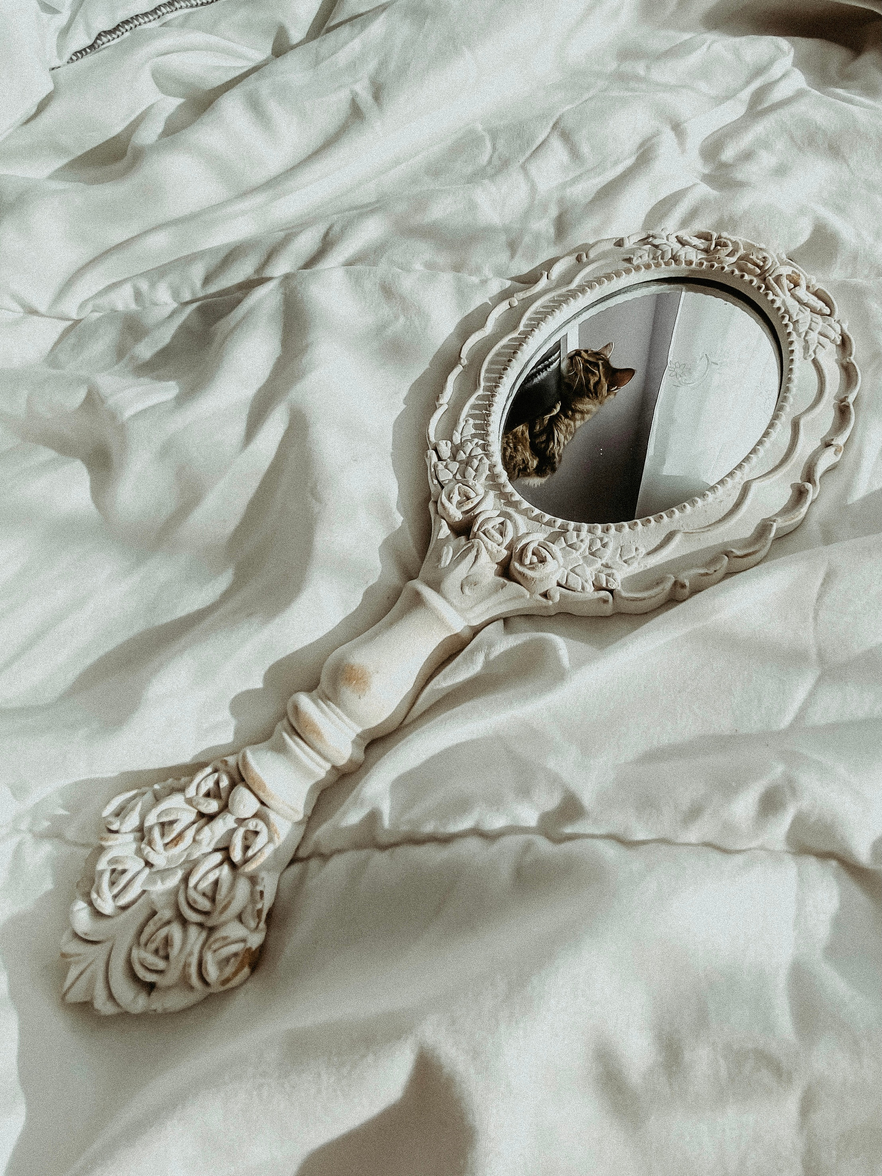 Victorian Hand Mirror on White Textile